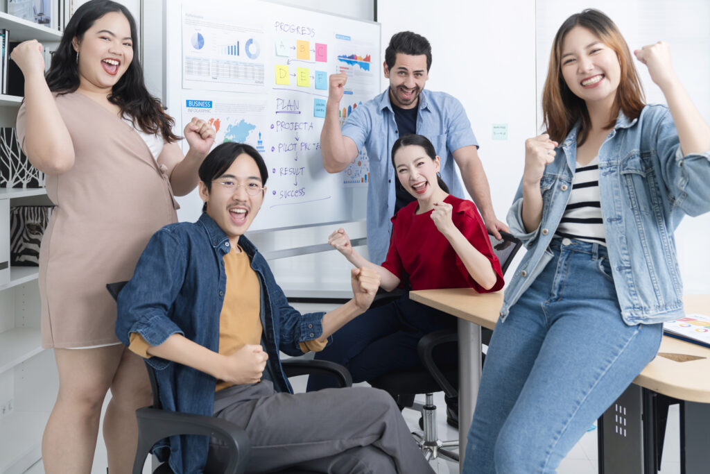 Smart asian startup small entrepreneur  standing confident portrait with  friends partner casual meeting brainstorm with white board and business financce paper chart anslysis in office background